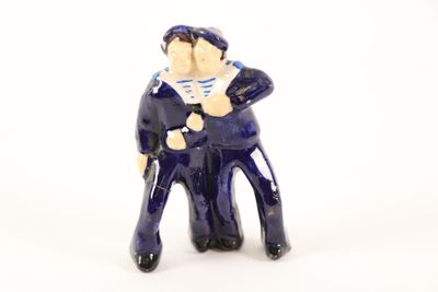 a small figurine of a man in a sailor ' s outfit