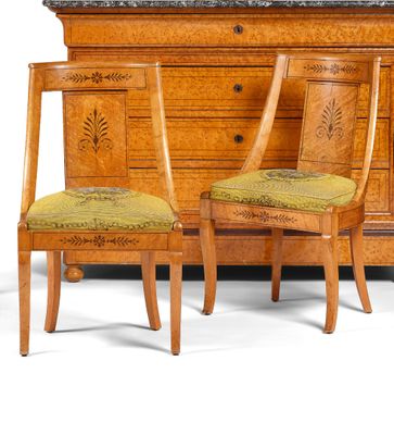 two chairs and a dresser with a marble top in a room