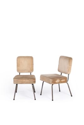 two wooden chairs with metal legs sitting next to each other on a white surface