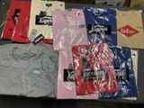 a lot of t - shirts that are on a table