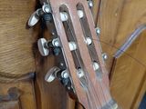 a close up of a guitar hanging on a cabinet
