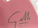 a pink heart shaped object with a signature on it