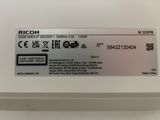 the label on the back of the ricoh printer is clearly visible