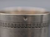 silver plated cup with a design on the rim