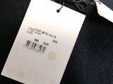 a label on the back of a sweater that says water with skis