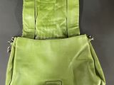 a green purse with a metal buckle on the front