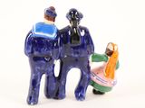 two figurines of a man and a woman standing next to each other