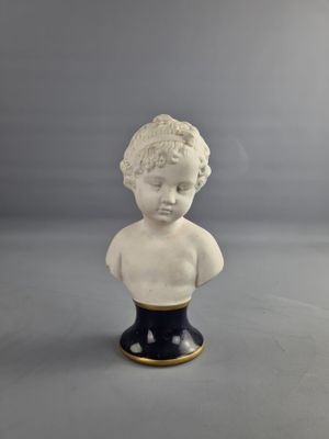 a small bust of a boy on a black base
