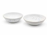 two white and blue bowls with designs on them on a white surface