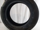 a close up of a tire on a white surface with a white curtain in the background