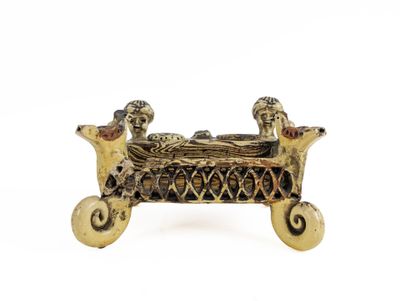 an image of a bronze figurine of a man and woman in a boat