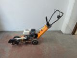 a small lawn mower that is sitting on the floor