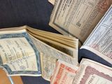 a pile of old paper and old books on a table