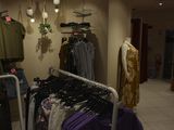 a rack of clothes in a clothing store with clothes on hangers