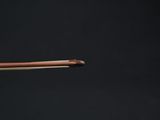 a close up of a person holding a piece of copper wire in their hand