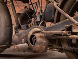 a close up of an old motorcycle parked on the street