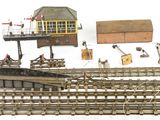 a lot of toy train tracks and a small building
