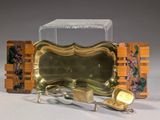 une assiette en or avec une cuillère et un repose-cuillère posés sur une table