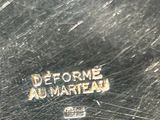 a close up of a silver plate with a logo on it