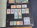 a lot of stamps on a table with a roll of paper