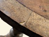 a close up of a wooden table with a clock on it