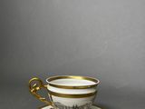 a close up of a cup and saucer on a table