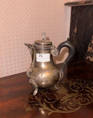 a silver tea pot sitting on a table with a name tag on it