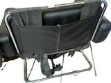 a black chair with a black seat and a black bag on it
