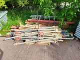 a pile of wood sitting on the ground next to a fence