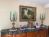 a painting on the wall above a dresser in a living room