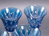 three blue glass vases sitting on top of a table