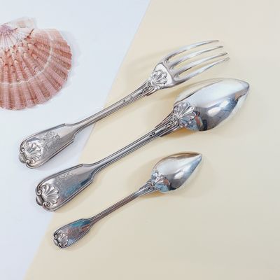 four silver spoons and two silver spoons on a table
