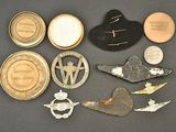 several different types of military badges and pins on a black surface