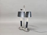 a lamp that is sitting on a table with a bird on it