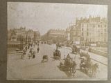 an old photo of a city street with horse drawn carriages