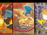 four different pokemon cards are displayed on a shelf in a store