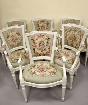 six chaises blanches avec des coussins rembourrés à motifs floraux dans une pièce