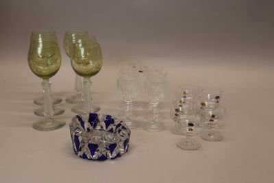 many glasses and a bowl sitting on a table