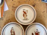 three plates with different designs on them sitting on a table