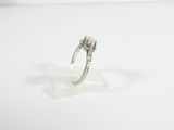 an image of a diamond ring sitting on top of a clear piece of glass
