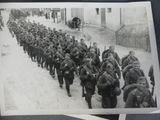 a lot of soldiers that are walking down the street