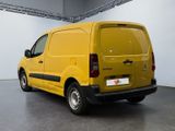 the yellow van is parked in a large room with a white wall