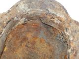 a rusted piece of metal with a hole in it