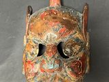 an image of a wooden mask on a table