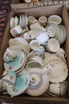 a box full of tea cups and saucers sitting on a table