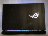 the asus rog strix is a gaming laptop with a keyboard and mouse