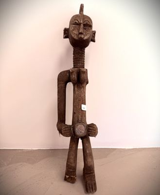 statue of a man holding a piece of wood in his right hand
