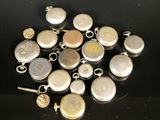 several different types of silver and gold charms on a black surface