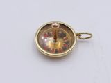 a picture of a small gold plated object on a white surface