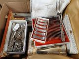 a box with a bunch of silverware inside of it